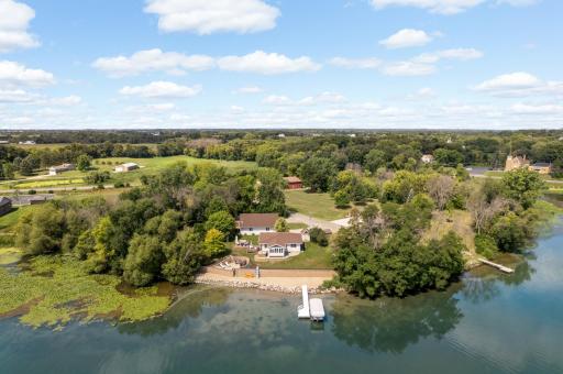 Aerial view highlighting the propertyâs lakeside setting and surrounding area.