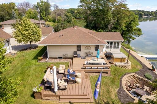 Freshly stained tiered wood deck with multiple areas for relaxing, grilling, and sunbathing.