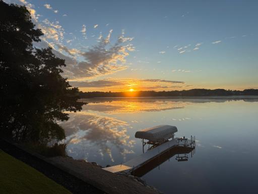 Sunrise reflected across the glass-like waters of Fish Lake.