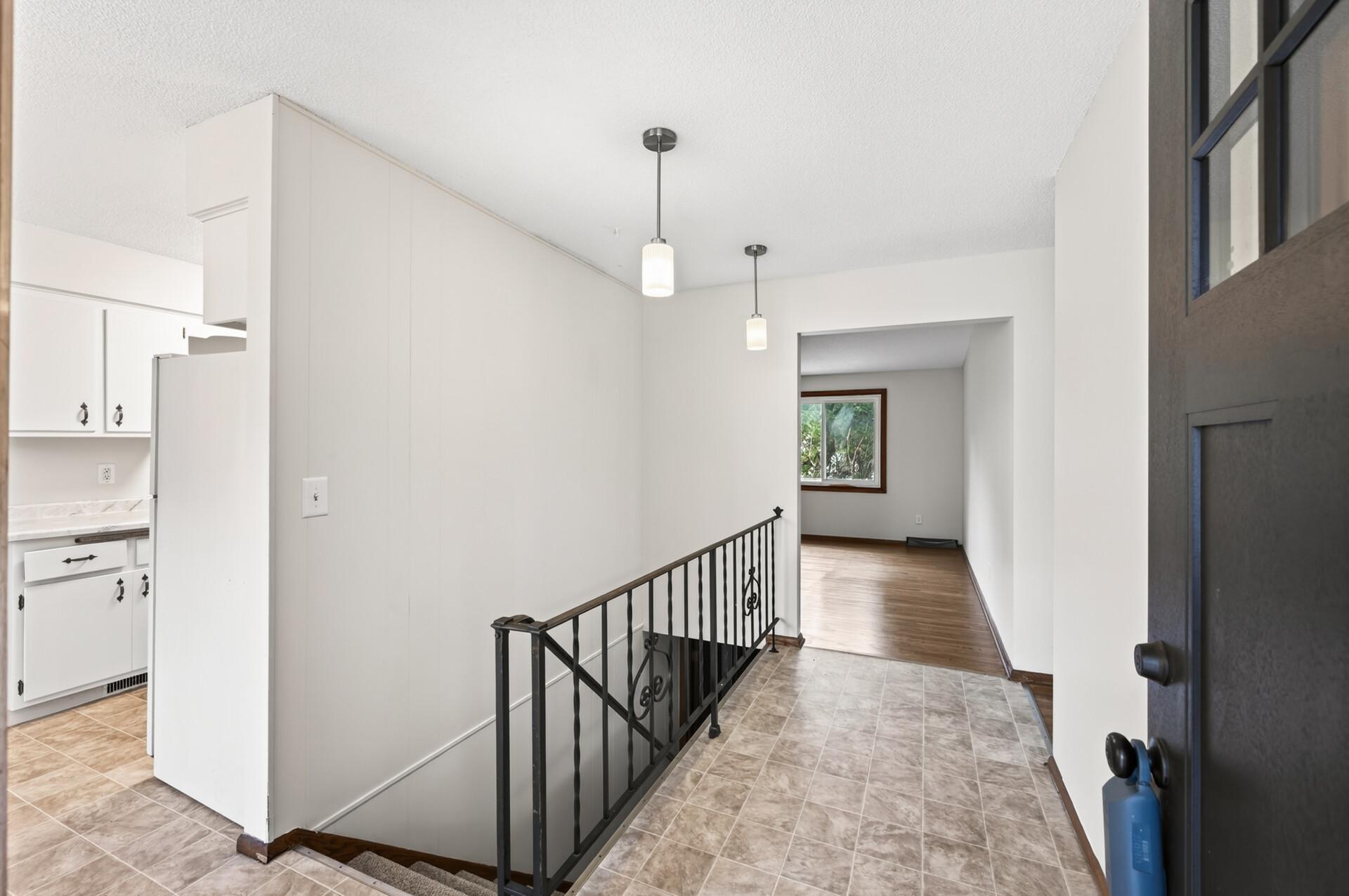 Entry and hallway with modern flooring and neutral palette.
