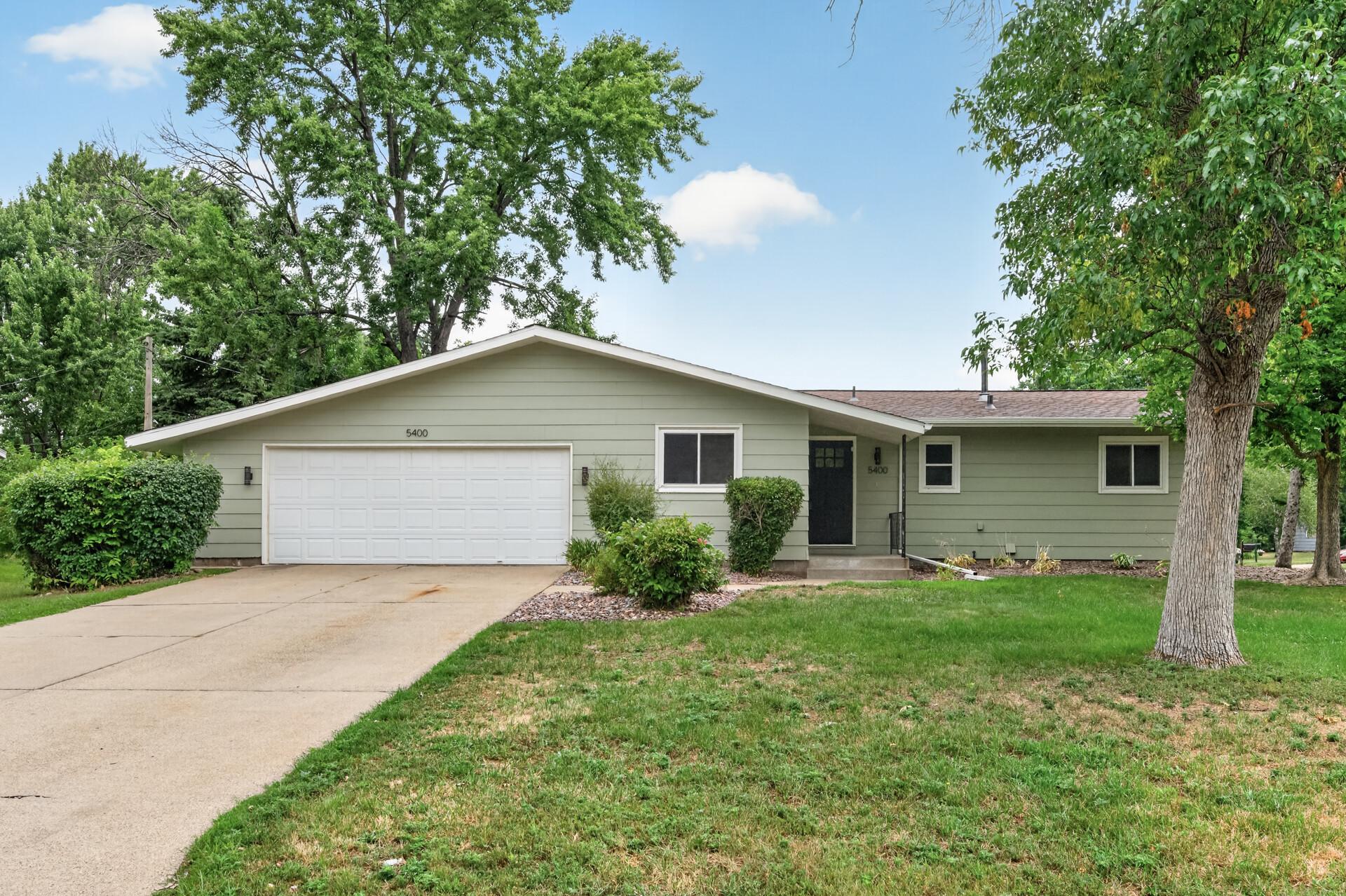 Welcoming front exterior with manicured lawn and driveway.