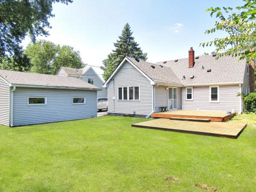 View of back of home, garage and deck.