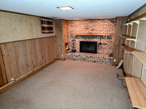 Lower-level family room with wood burning fireplace.