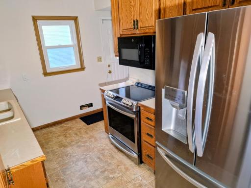 Galley kitchen w/ SS appliances.