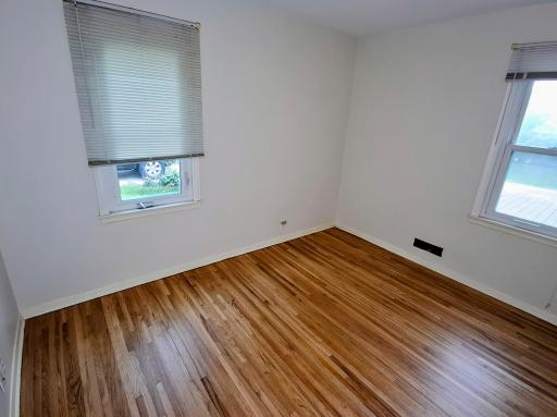 Bedroom 2 with oak refinished floor.