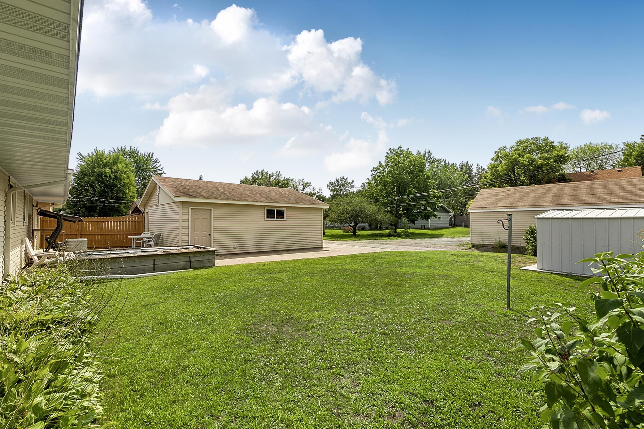 Architectural shingles, seamless rain gutters with leaf guards, and a concrete driveway add to the home's practicality and ease of maintenance.