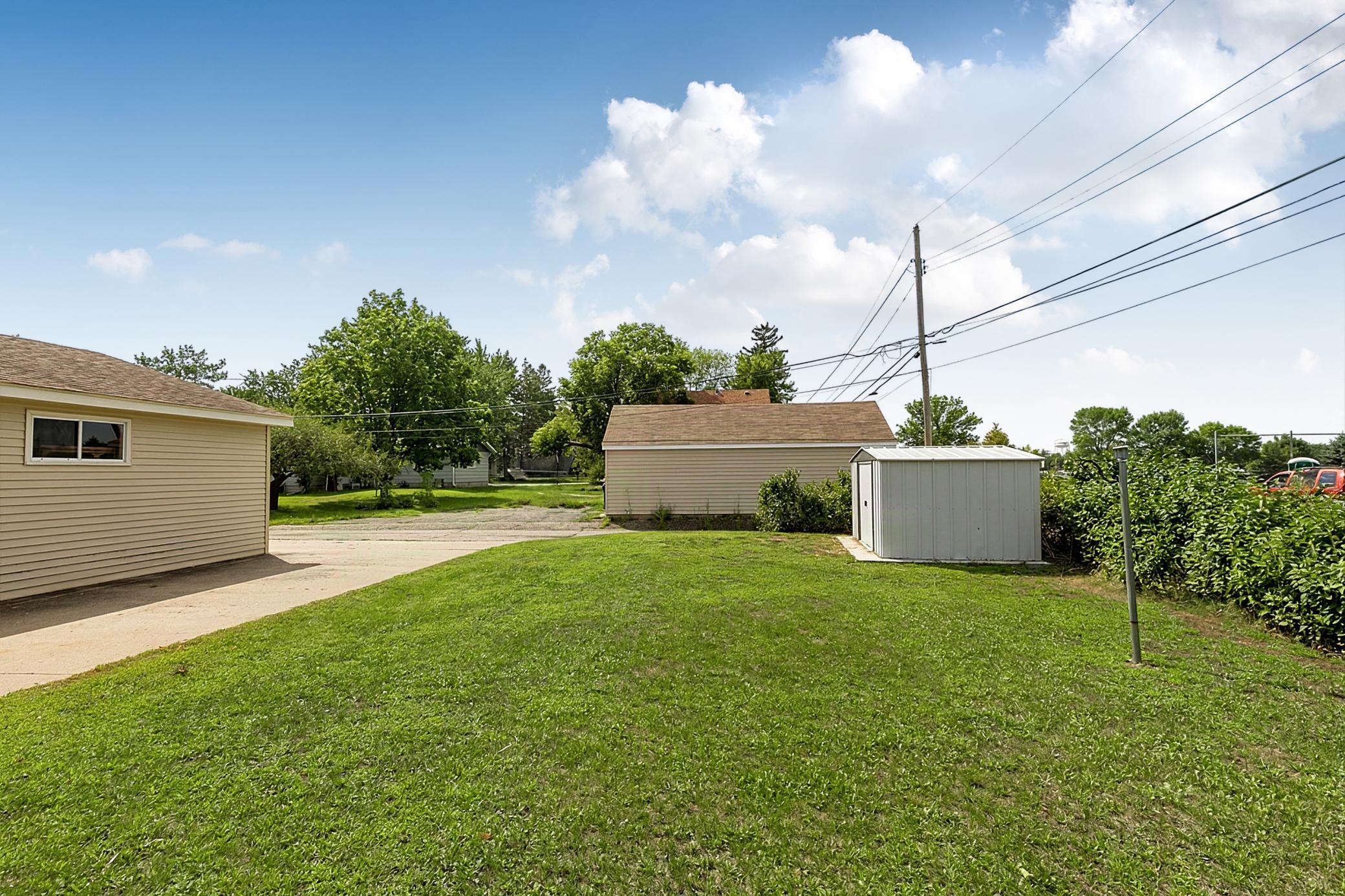 The backyard offers a clothesline option, raised garden space, and a newer 8' x 10' accessory shed for storing yard equipment.