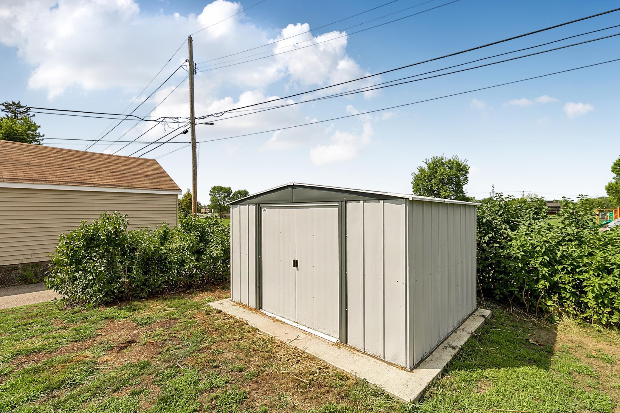The 8' x 10' accessory shed is situated on its own concrete pad.