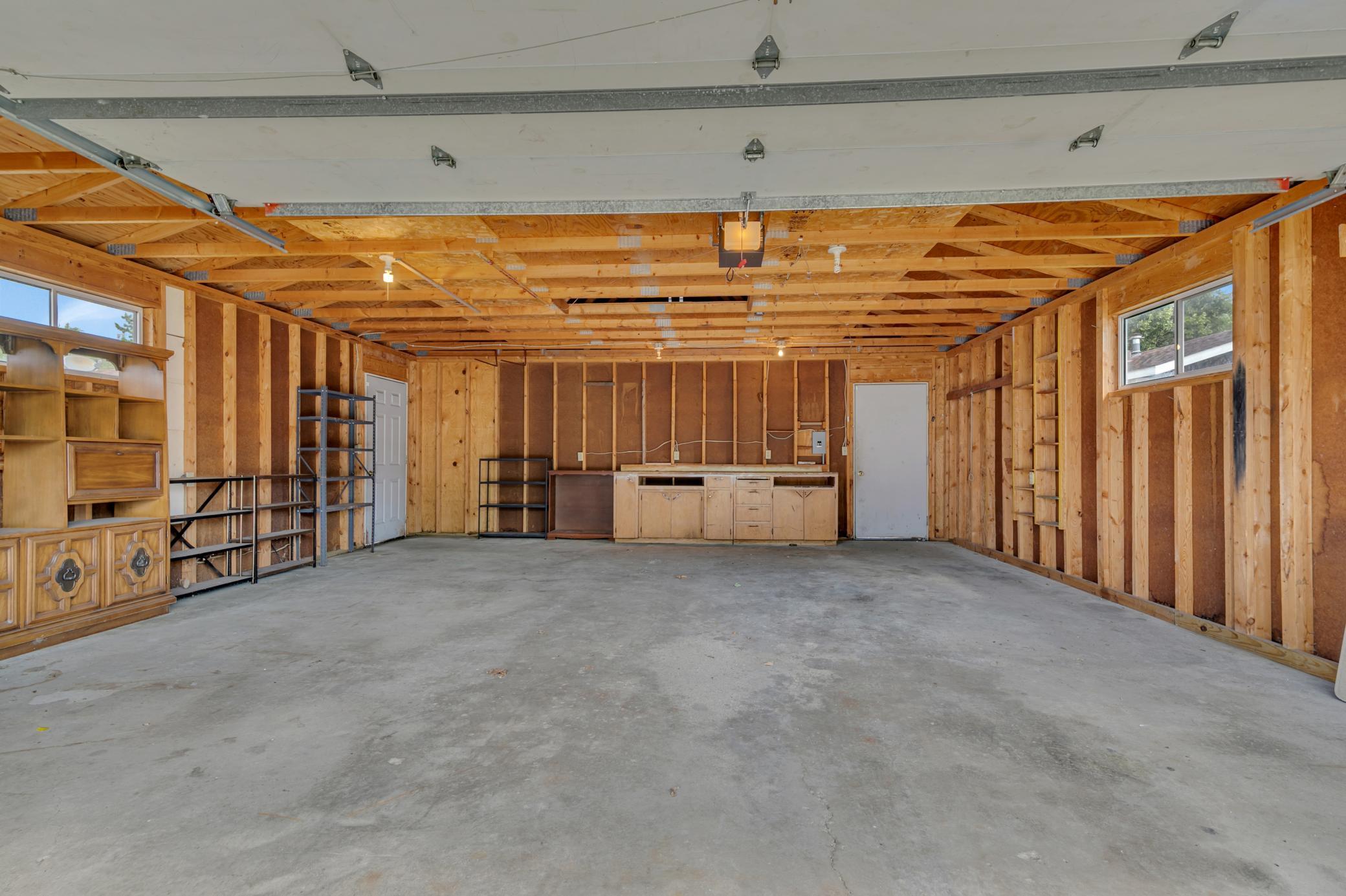 The detached garage features steel siding, electricity, a concrete floor, a LiftMaster 1/2-horsepower overhead door opener, and two service doors.