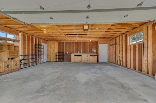 The detached garage features steel siding, electricity, a concrete floor, a LiftMaster 1/2-horsepower overhead door opener, and two service doors.