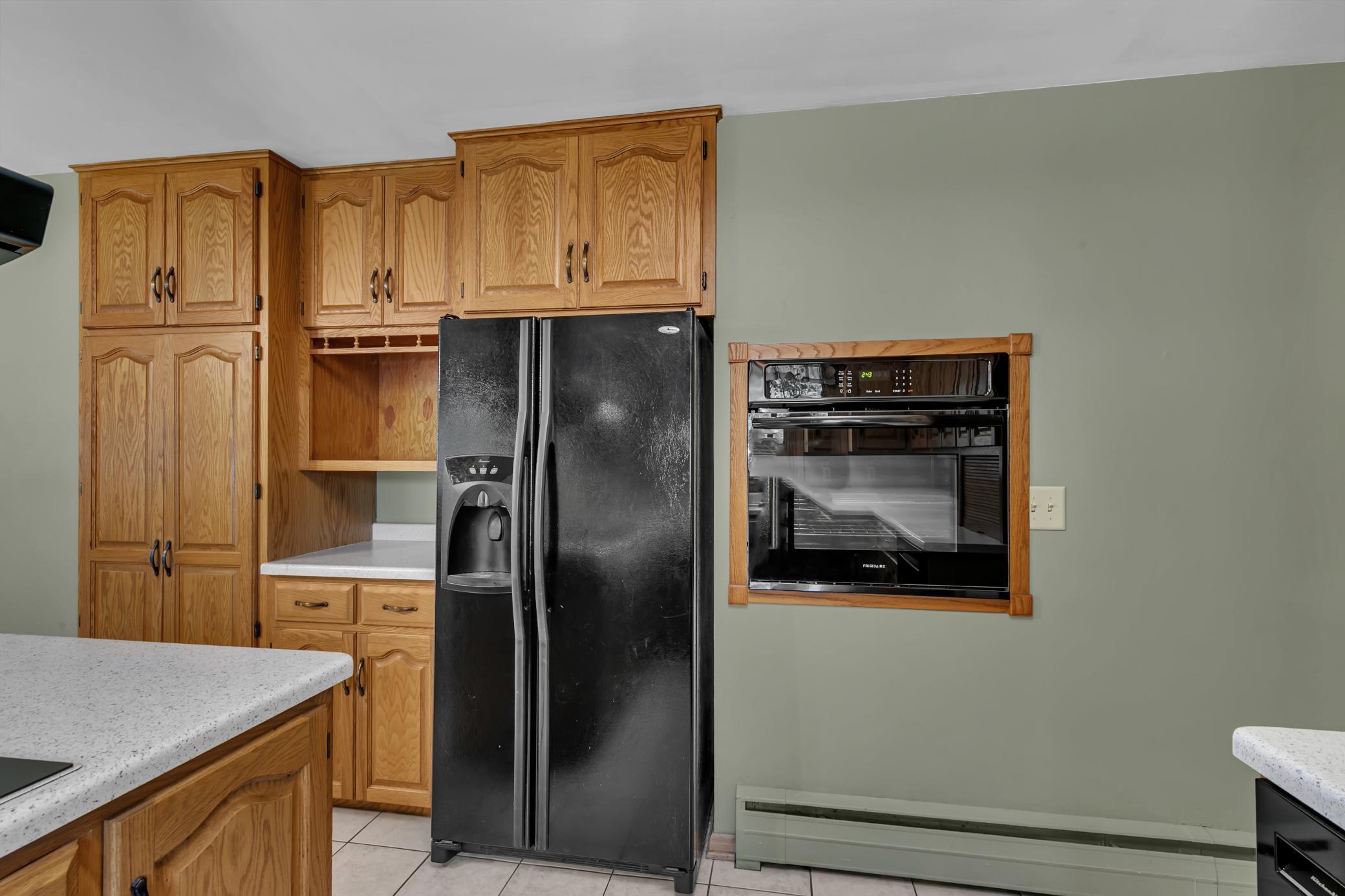 The refrigerator includes an ice maker and front water dispenser, along with a built-in water filtration system; the filter was replaced in July 2026, and a spare filter will remain with the home.