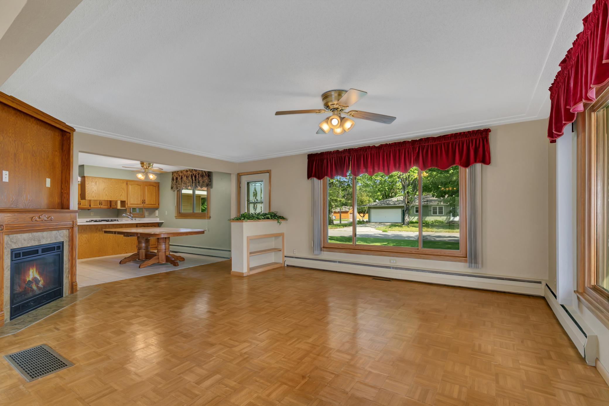 The Honeywell thermostat in the main-level living room controls heat for the east half of the home, while the primary/master bedroom thermostat controls heat for the west half.