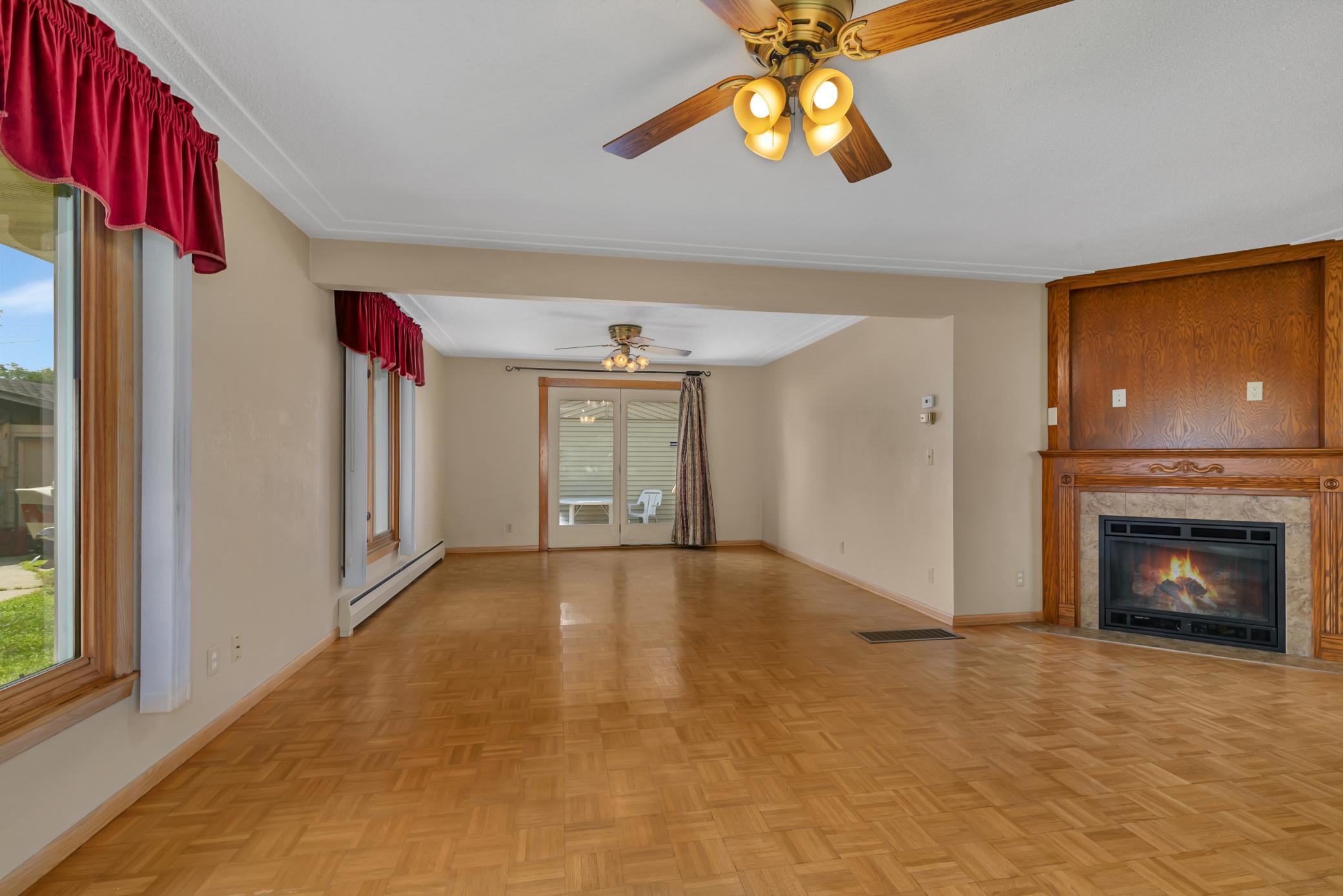 The living room features a gas fireplace with a tiled surround and wood mantel, creating a warm focal point for relaxing or entertaining.