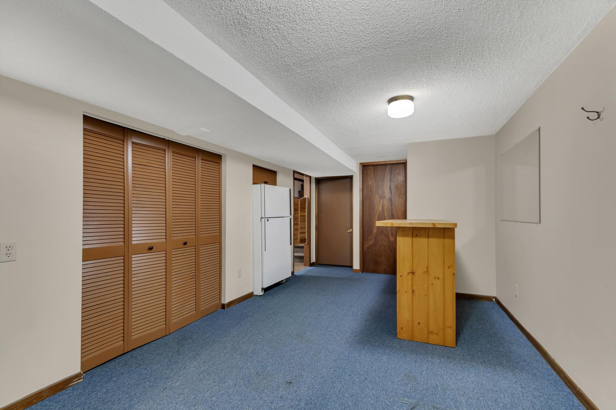 Room off the family room with a bar and space for a refrigerator making this a great game room!