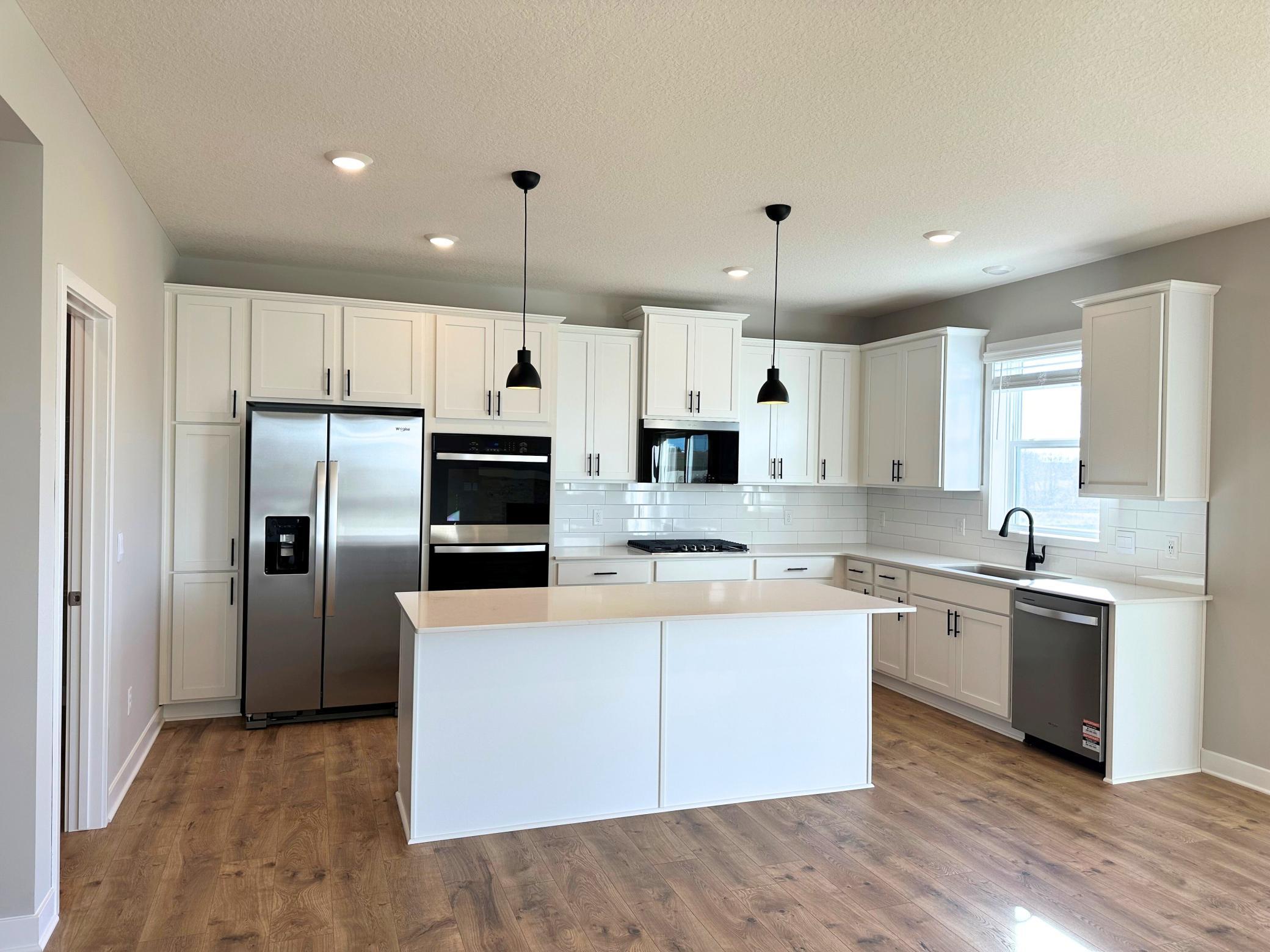 Upgraded Signature Kitchen includes double wall ovens, gas cooktop, and the latest microwave which includes an air fryer!