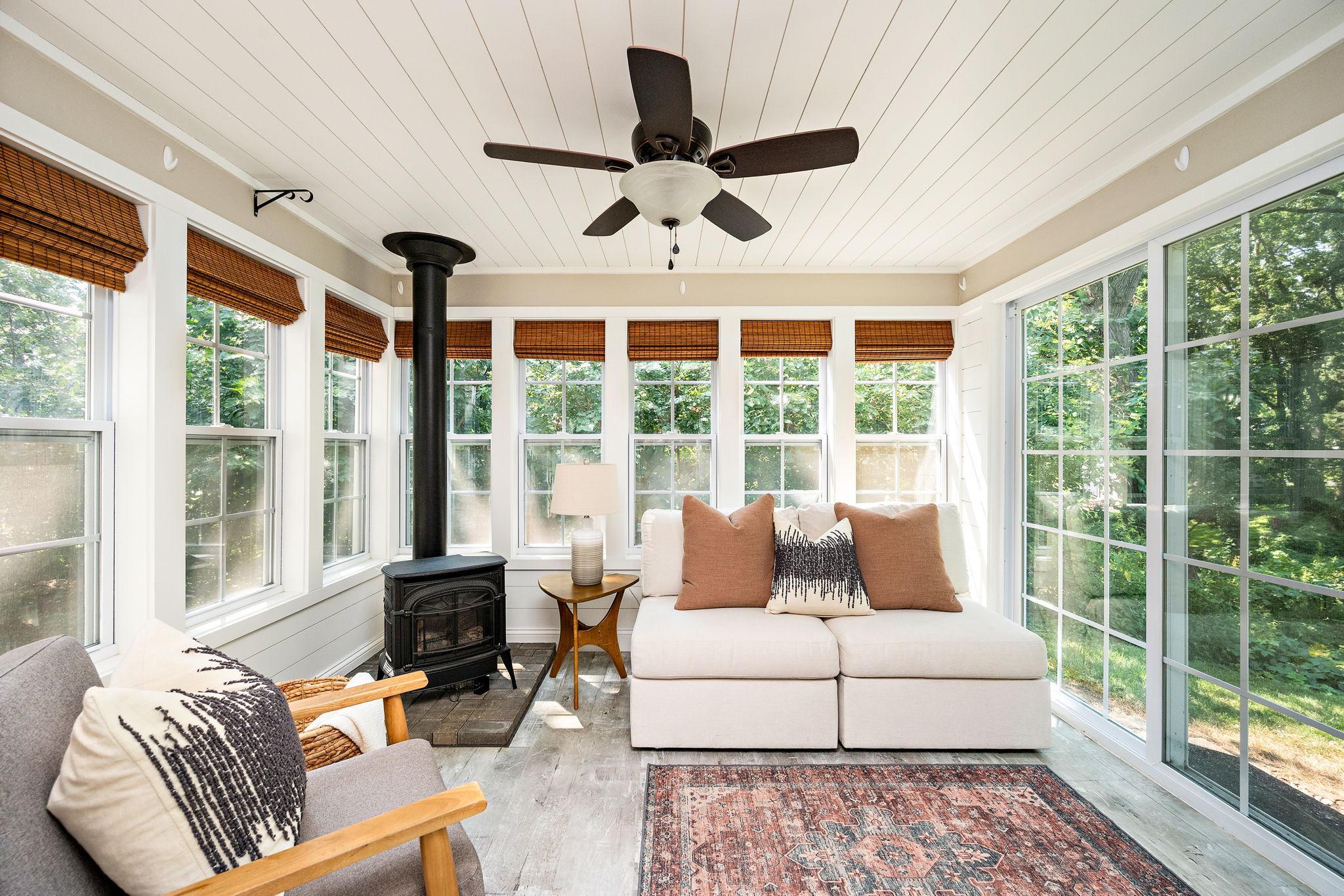 Wonderful sunroom boasts a Franklin stove for fall and winter use!