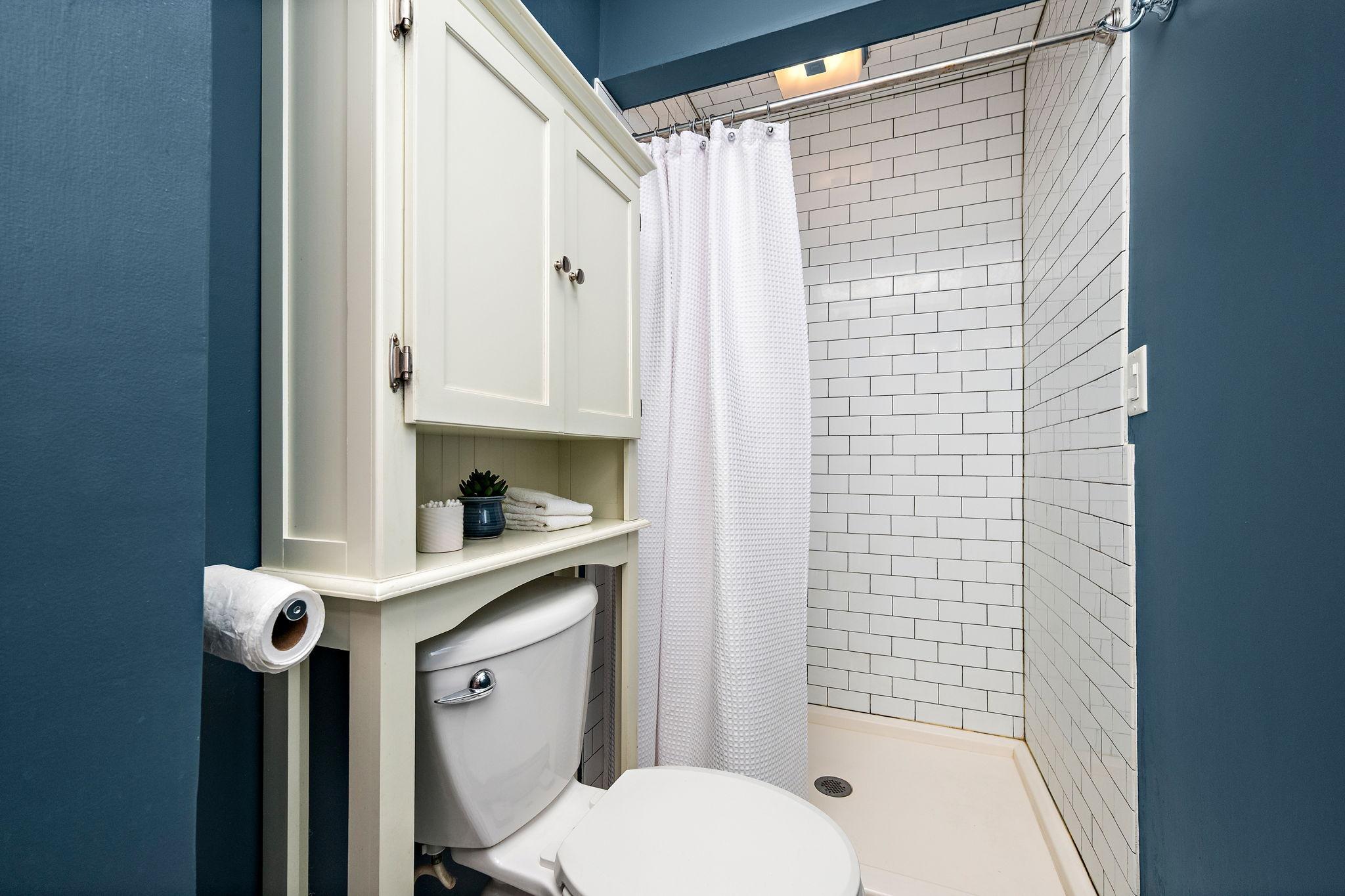 The seller added a shower to this tile bathroom!