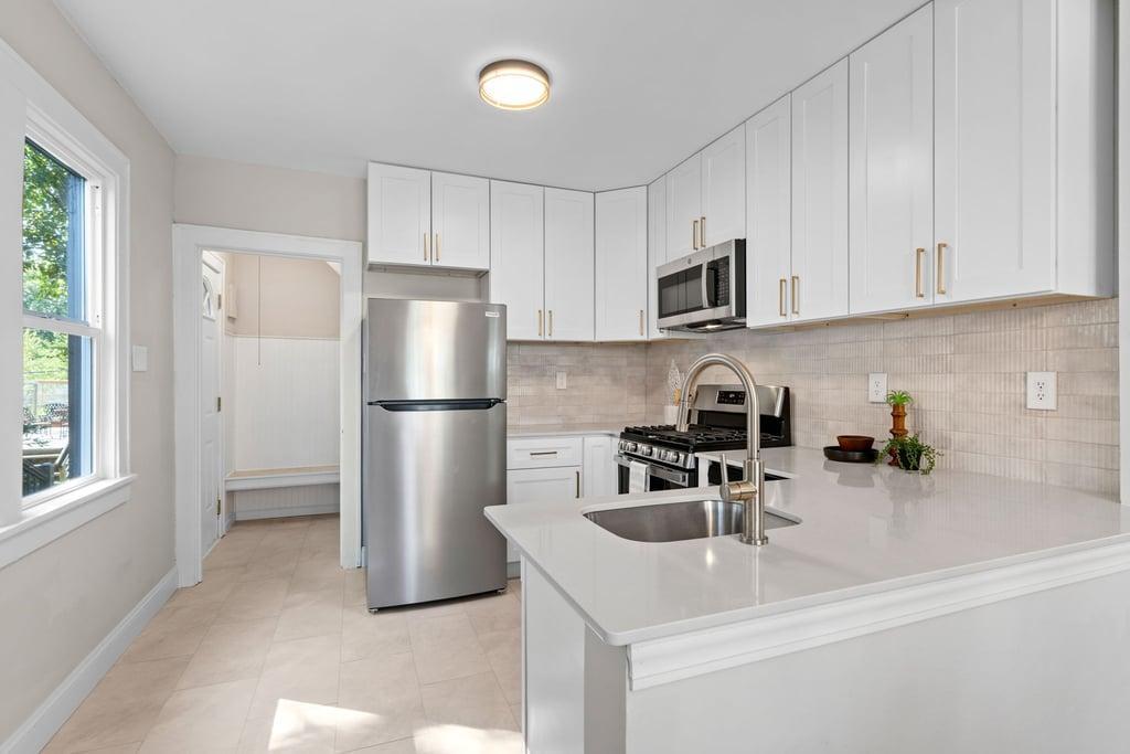 Remodeled Kitchen - New Cabinets, Quartz Countertops, Stainless Steel Appliances, and Tiled Backsplash