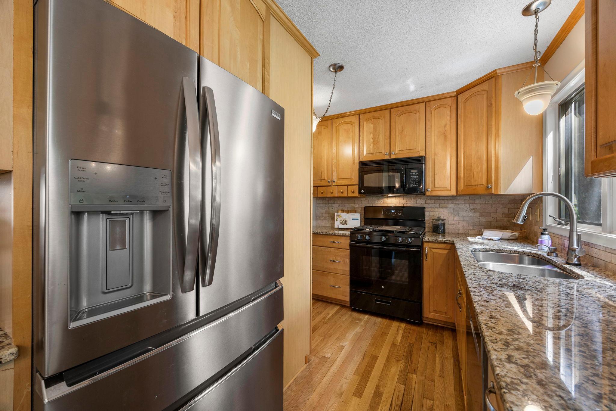 Abundant cabinetry, granite countertops, and generous counter space!