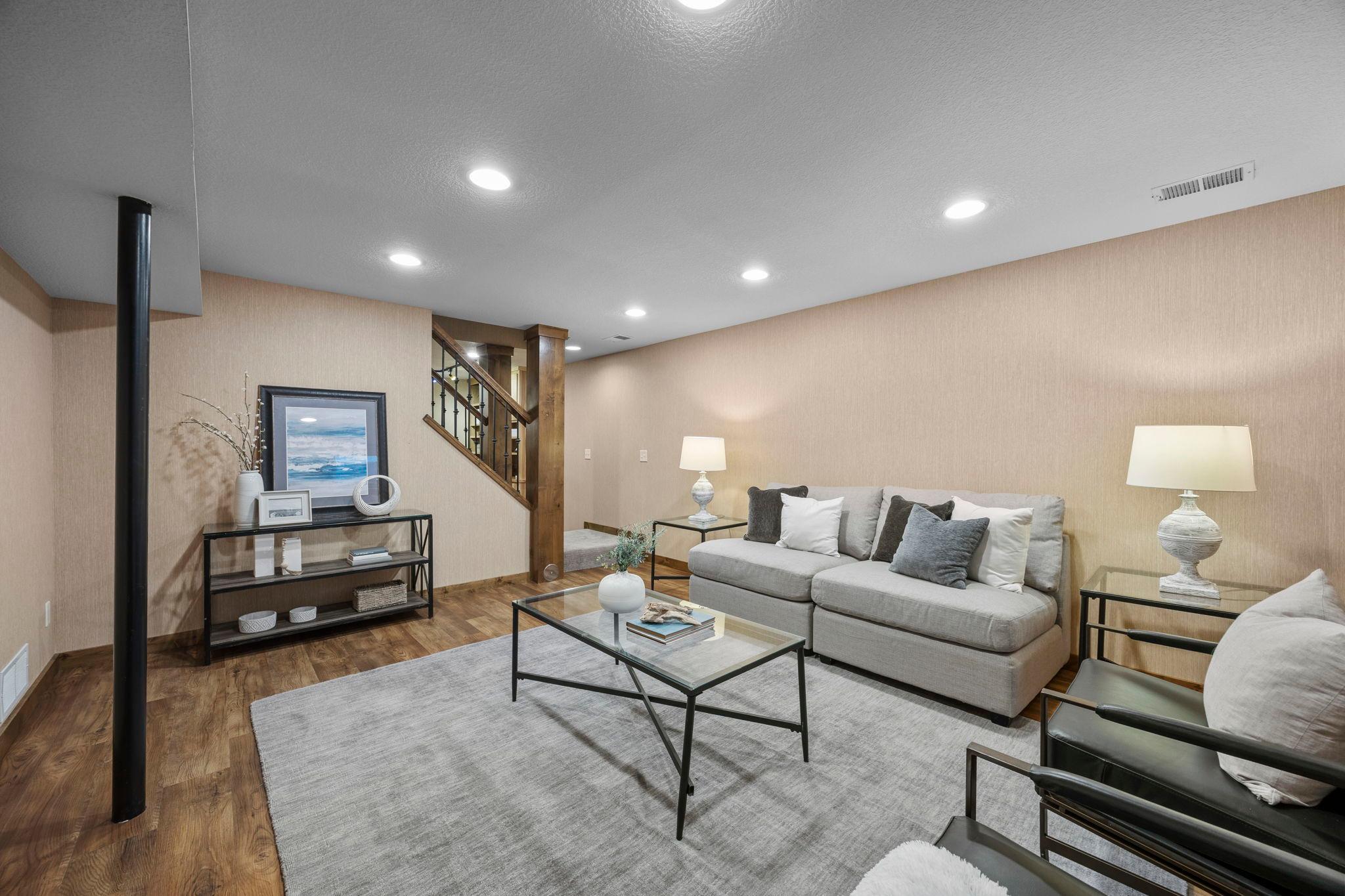 The lower level adds a whole new layer of flexibility, with spaces designed for both everyday living and the hobbies that make a home feel personal.