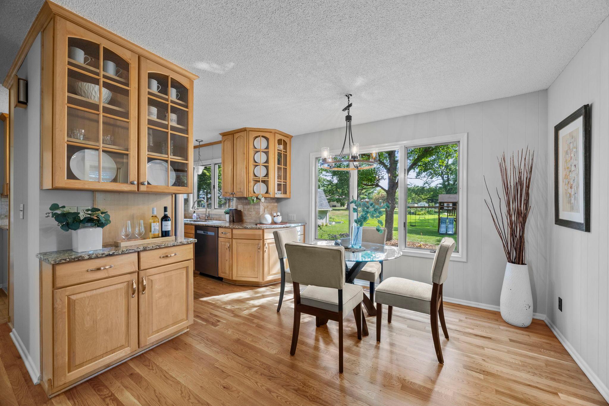 Enjoy a buffet serving area with glass-front cabinetry that adds both functionality and a thoughtful touch for entertaining.