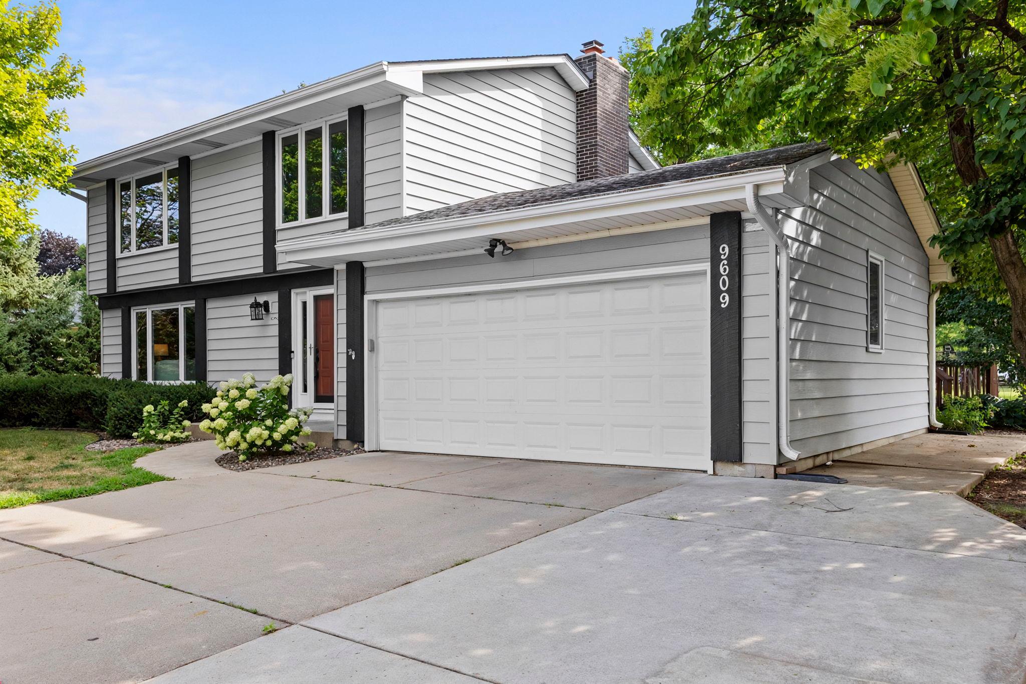 A dedicated parking pad by the driveway provides additional space for vehicles, trailers, or guests.