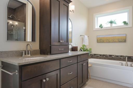 Private primary bath with dual sinks, soaking tub and separate shower.