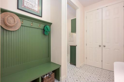Large coat closet just off garage with build-in bench.