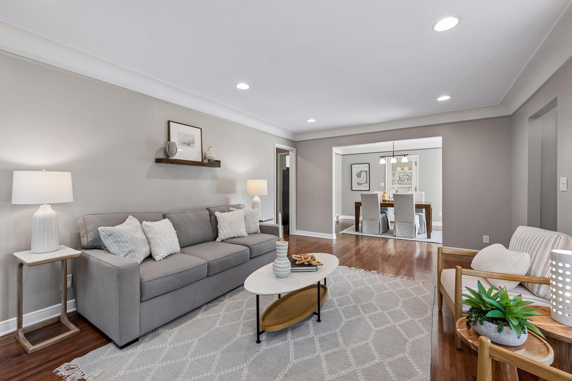 19x13 main-floor living room with a wood-burning fireplace, hardwood floors, and coved ceilings. South and west-facing windows.