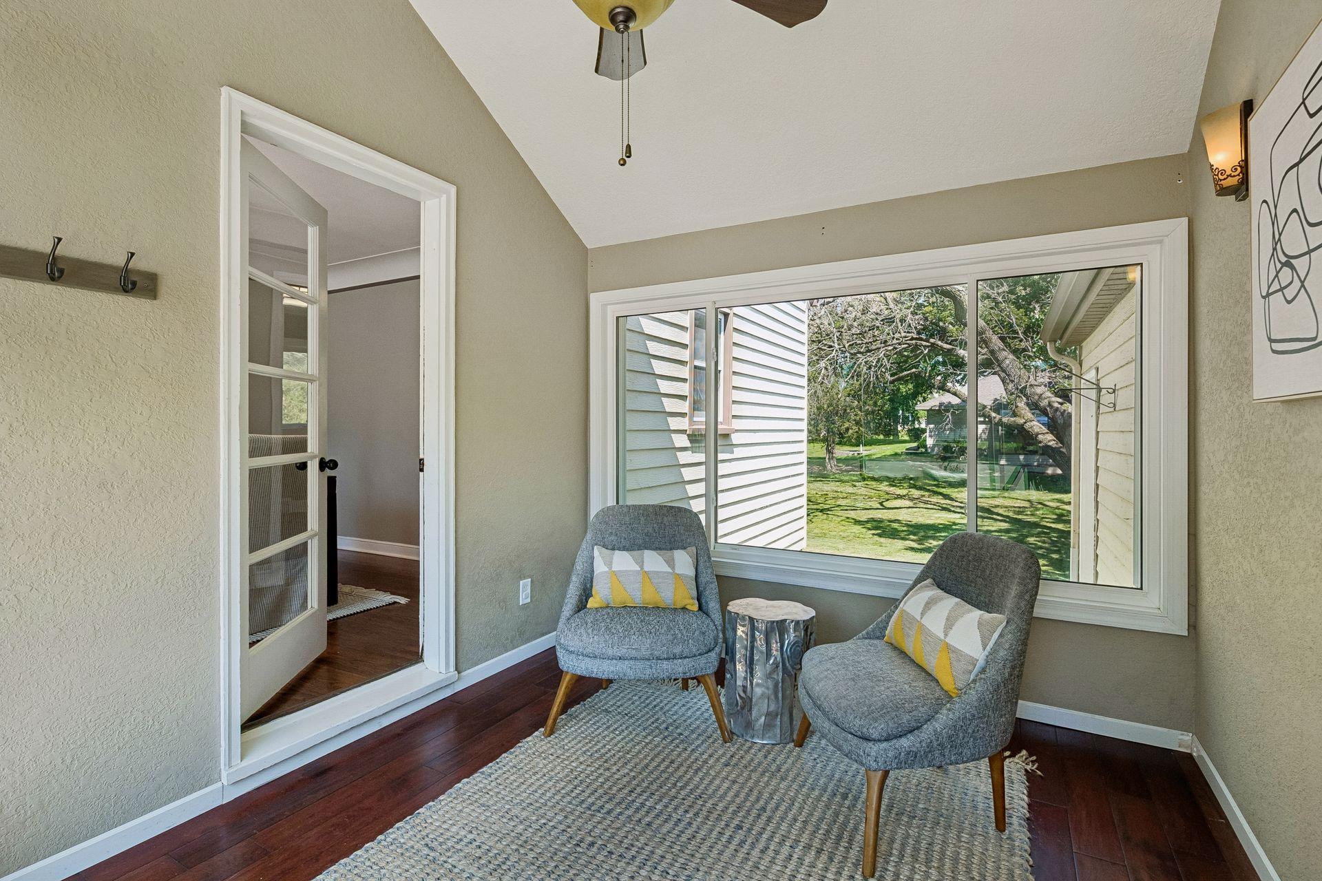 12x7 Breezeway bonus room with glass French doors to the dining room, north and south-facing windows.