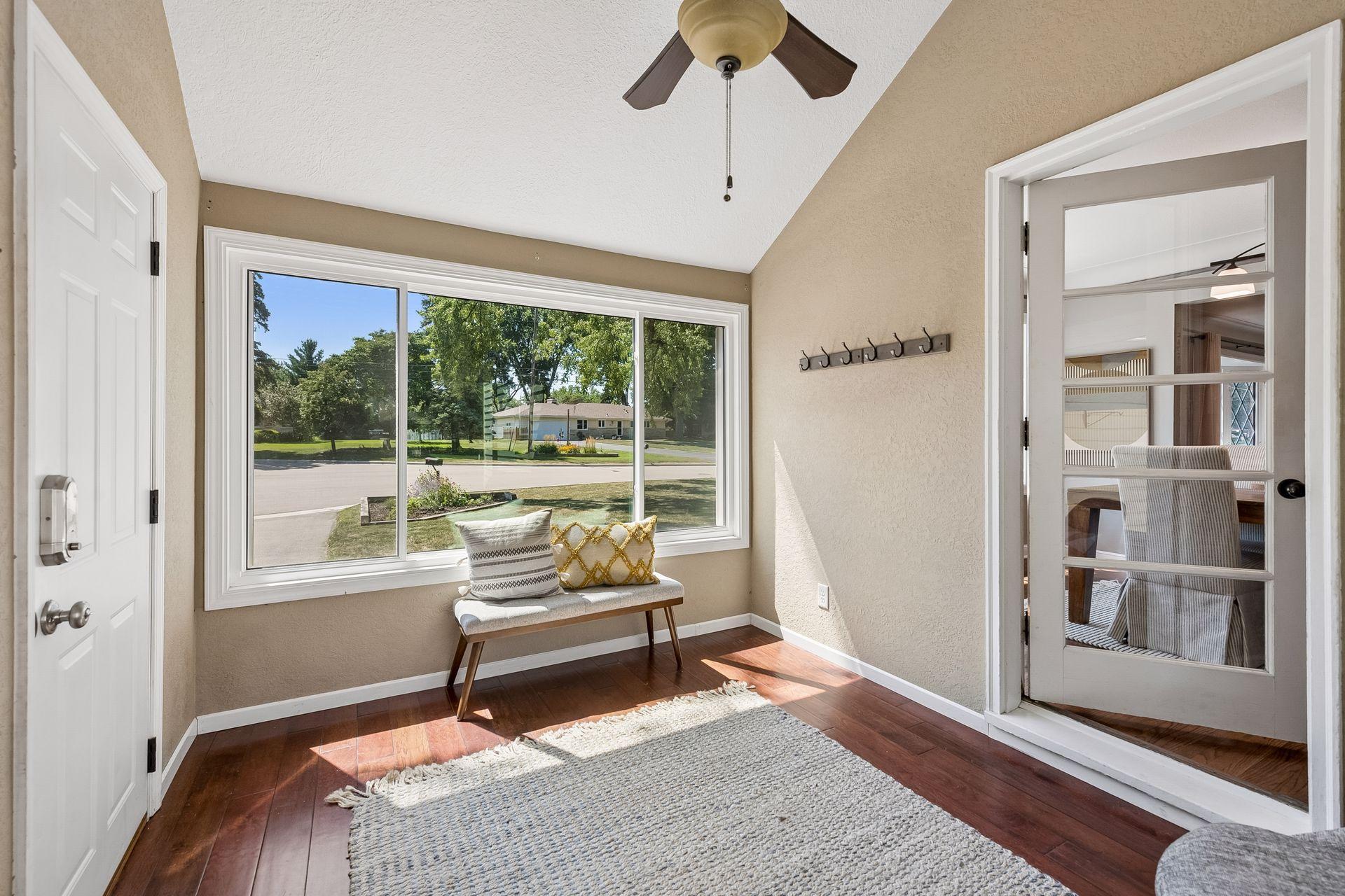 12x7 Breezeway bonus room with glass French doors to the dining room, north and south-facing windows.