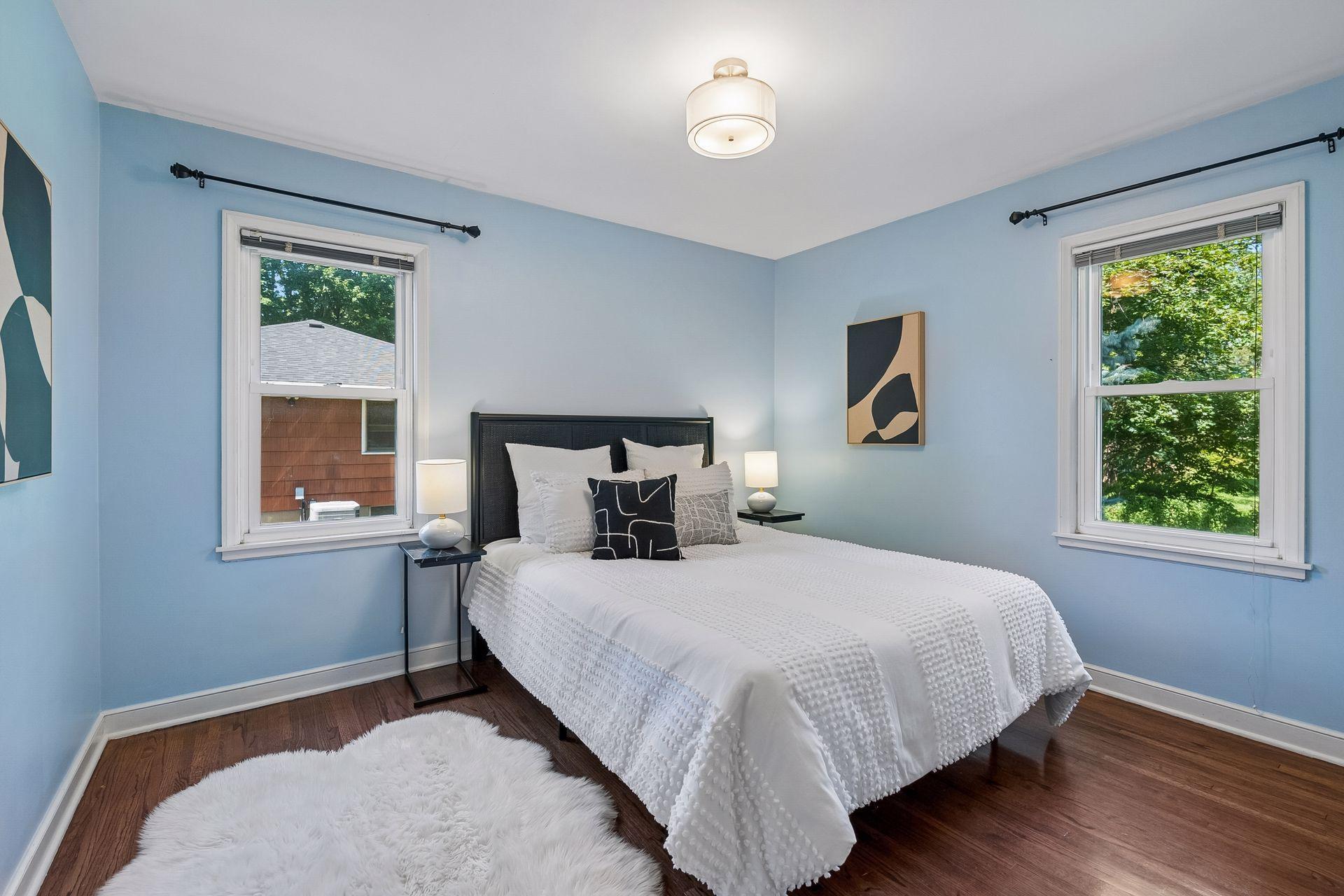 12x10 Main Floor Bedroom with White enameled Trim and Hardwood floors. North and west-facing windows.