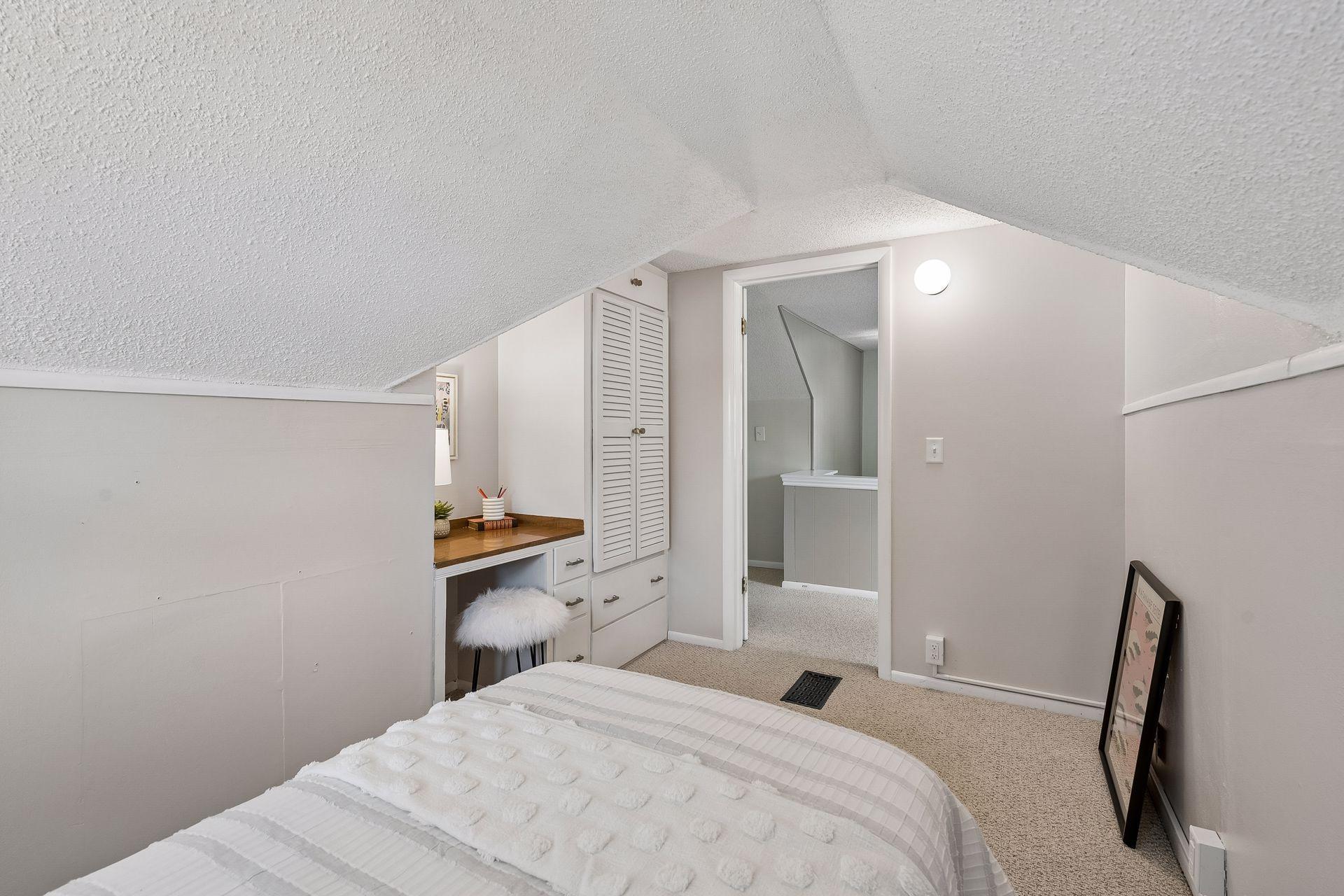 12x8 Upper Level bedroom #3 with White trim, built-in desk, and Carpeted floors.