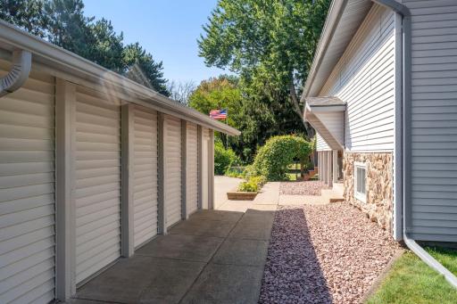 Walkway between the home and detached 2 car garage.