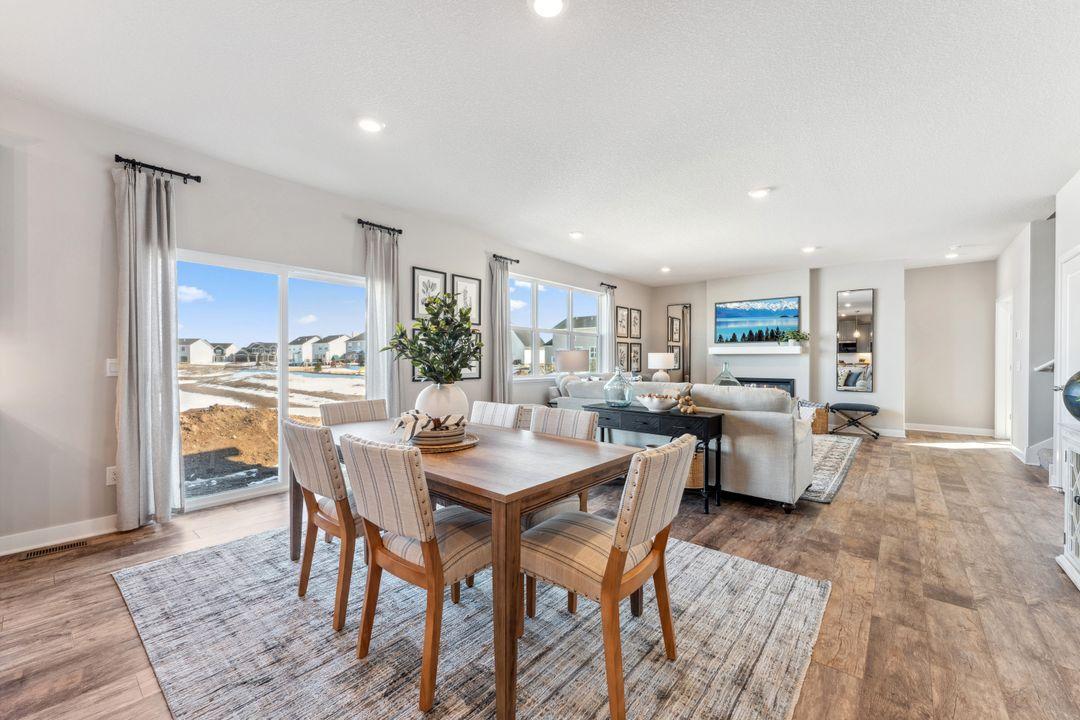A spacious informal dining area joins the kitchen and living room. Photo of model home, colors and finishes are similar.