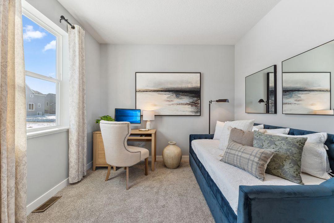 The 5th bedroom is located on the main floor and apart from the living area. Photo of model home, colors and finishes are similar.