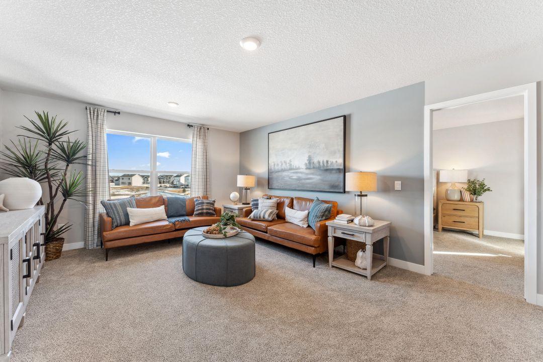 Another view of the second floor loft. Note the entry to a secondary suite. Photo of model home, colors and finishes are similar.