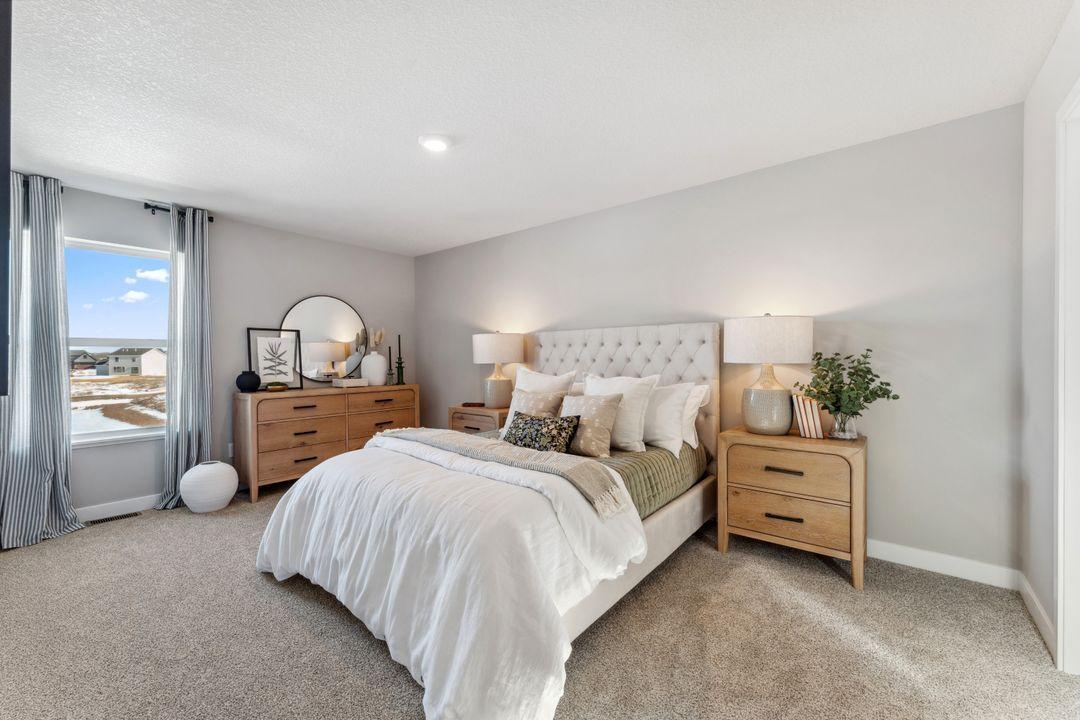 WOW! There's a secondary suite upstairs with a private 3/4 bath and large walk in closet. Photo of model home, colors and finishes are similar.