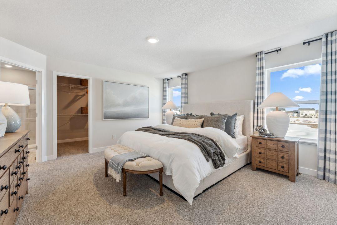 Your spacious primary suite has a private bath and separate oversized walk in closet. Photo of model home, colors and finishes are similar.