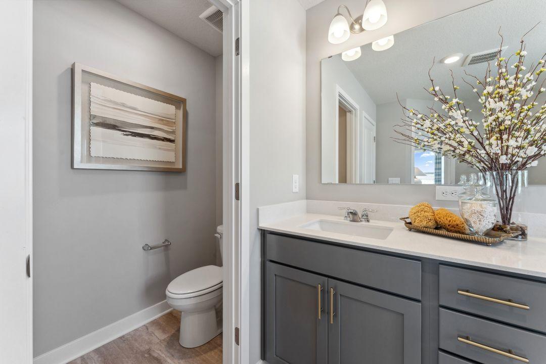 Private water closet in the primary suite. Photo of model home, colors and finishes are similar.