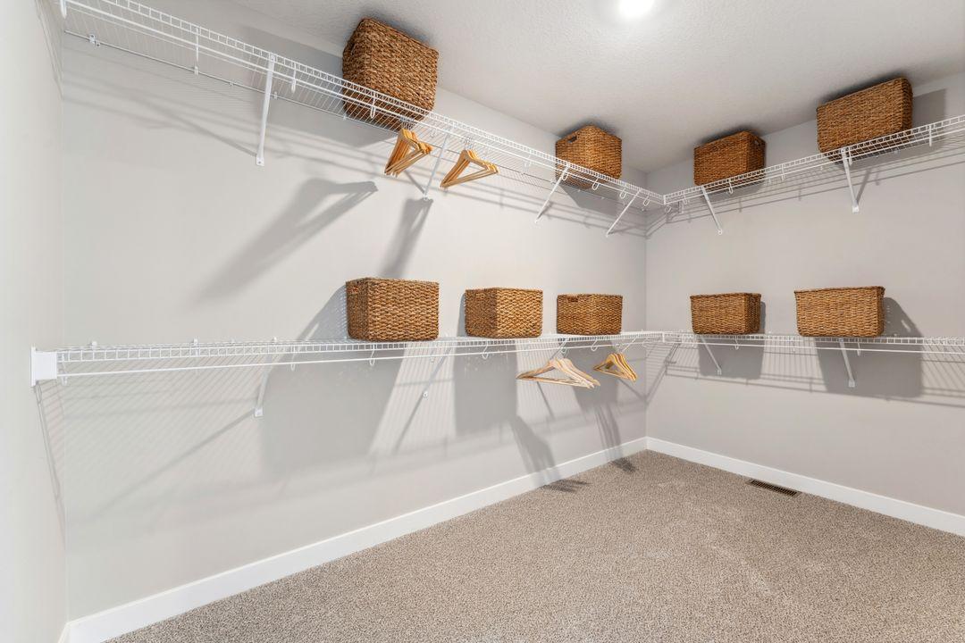 Extra large walk in closet in the primary suite. Photo of model home, colors and finishes are similar.