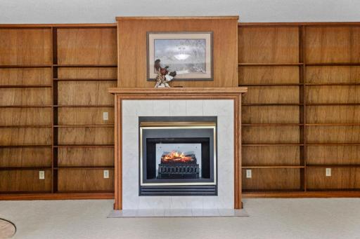 This electric fireplace is built in and adds warmth and ambience to this room.