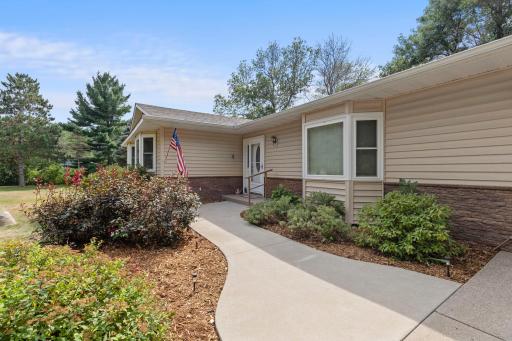 Sidewalk to front door with perennial gardens.