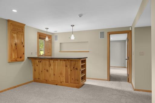 Lower level dry bar for entertaining with wine storage.