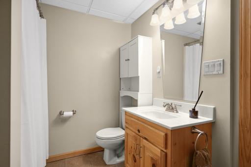 Lower level full bath walkthrough to oversized bedroom and family room.