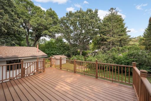 Large deck that overlooks the flat backyard.