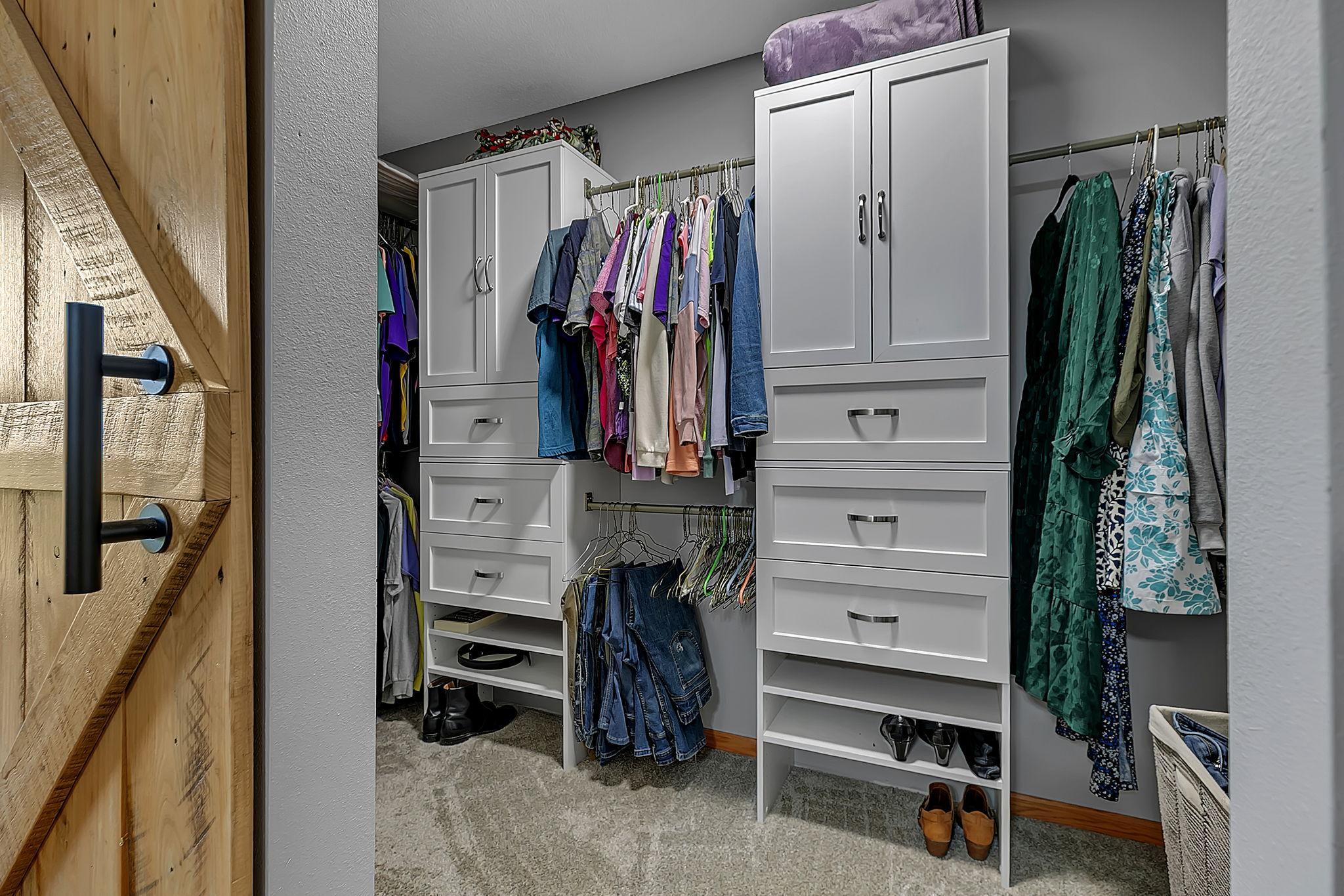 The walk in closet has built in shelving