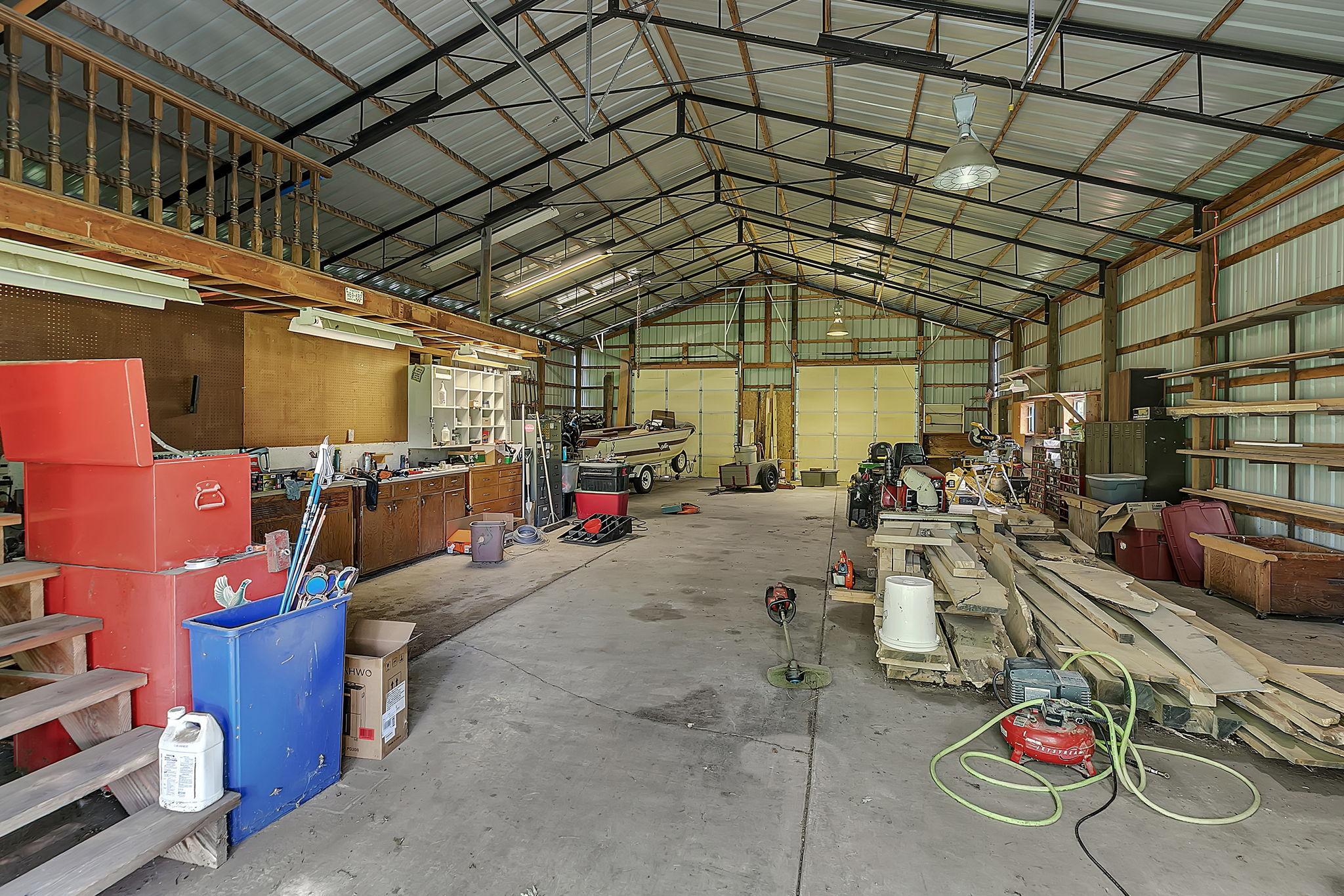 The 56x36' shed has concrete floors, power, and a workshop set up!