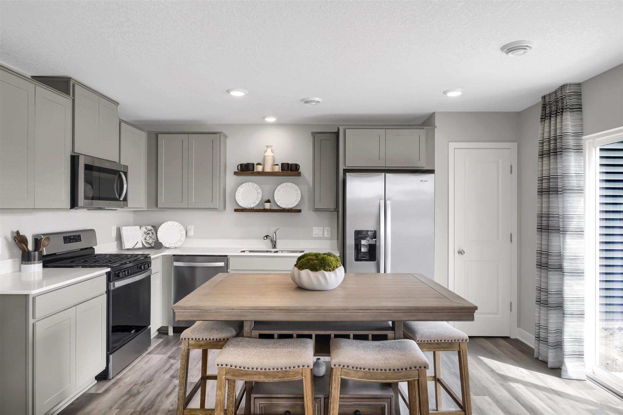 The open floor plan creates a space that seamlessly flows from kitchen and living space to your private outdoor living area. (Model photo, colors may vary)