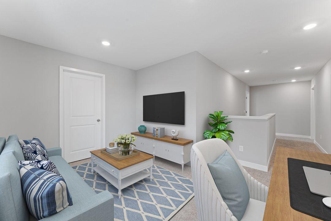 The bright loft is perfect for relaxing and it's window brings in light for the whole upper level. (Model photo, colors may vary)